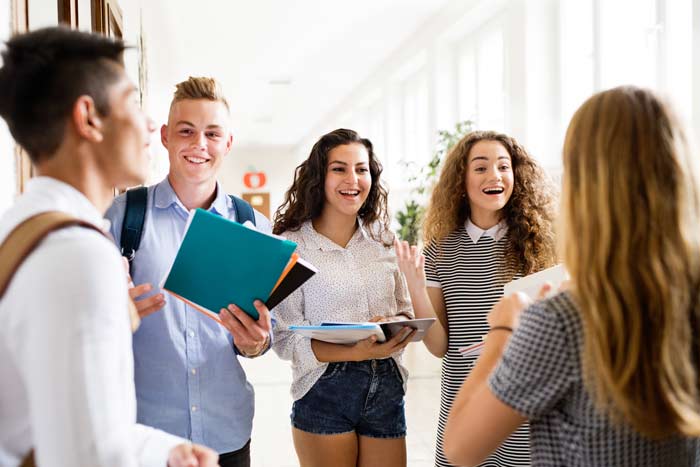 teenage-students-walking-in-high-school-hall